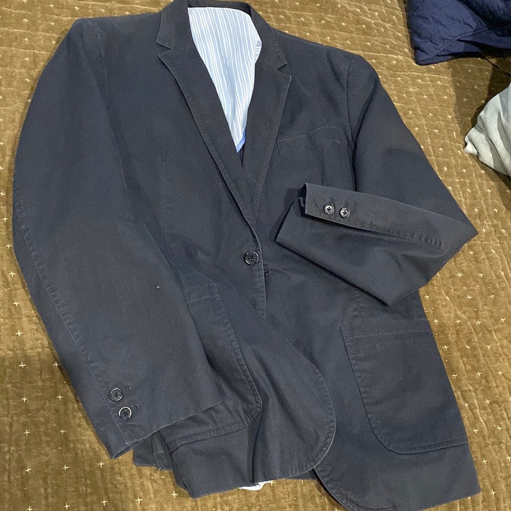 Unstructured navy jacket, light blue strip lining.